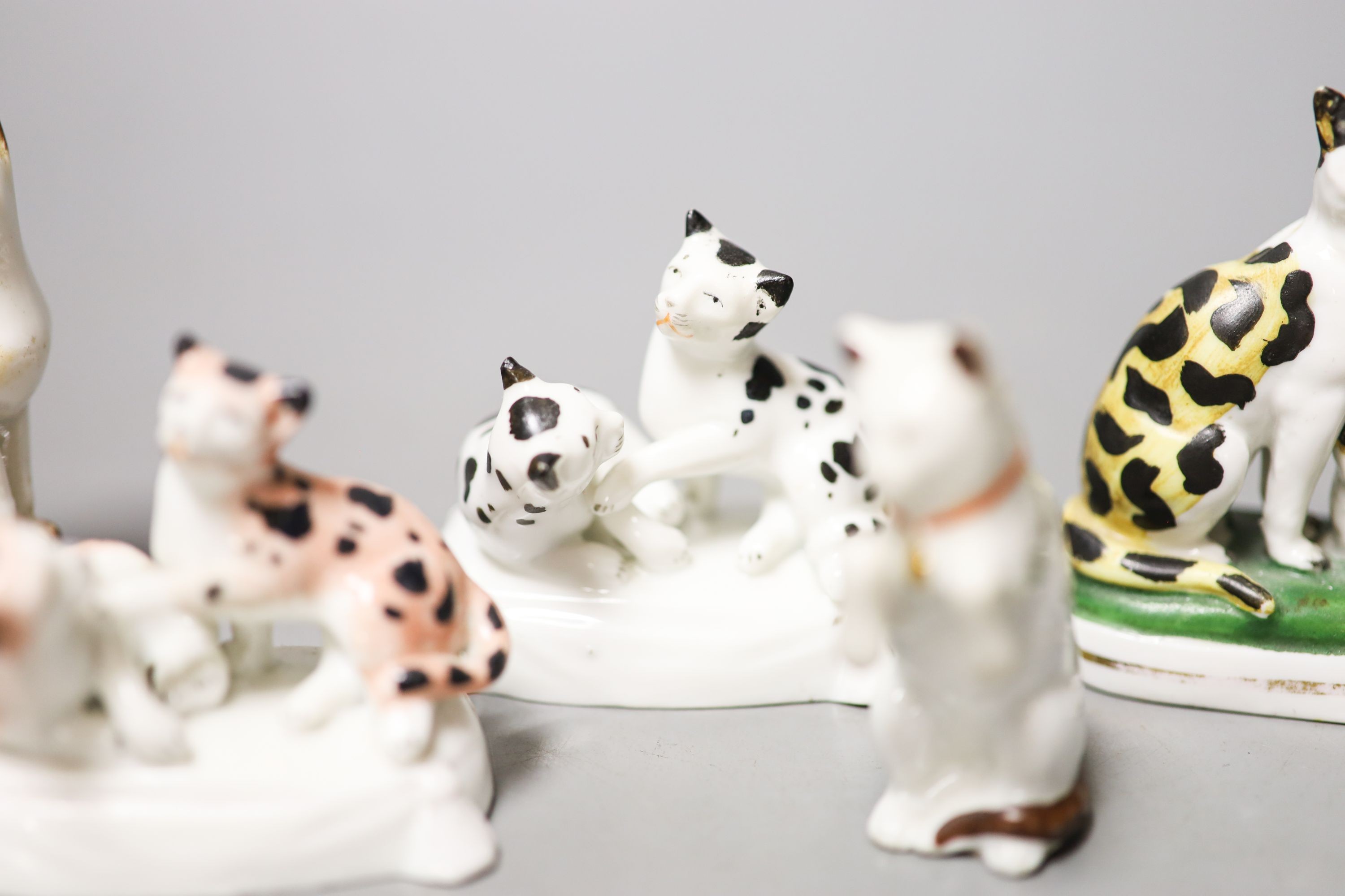 Six French porcelain cat figures or groups, and a similar sheep figure, late 19th century